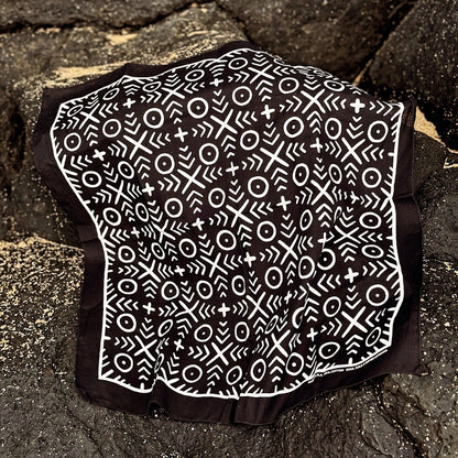 Bandana with black and white mud cloth patterned on a stone surface