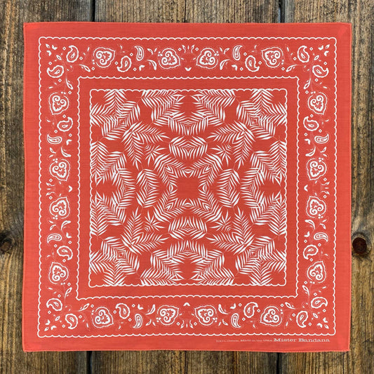 Our classic Wild Palms design, now in silky coral red. Inspired by the traditional cowboy scarf, this bandana easily ties into a Western knot, or pairs great with our Bison Leather Woggle. Material: 100% silky pima cotton. Provenance: printed and assembled in North Carolina. 21.5" x 21.5". Made in the USA 🇺🇸 